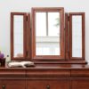 Antoinette dark mahogany gallery mirror resting above a chest of drawers