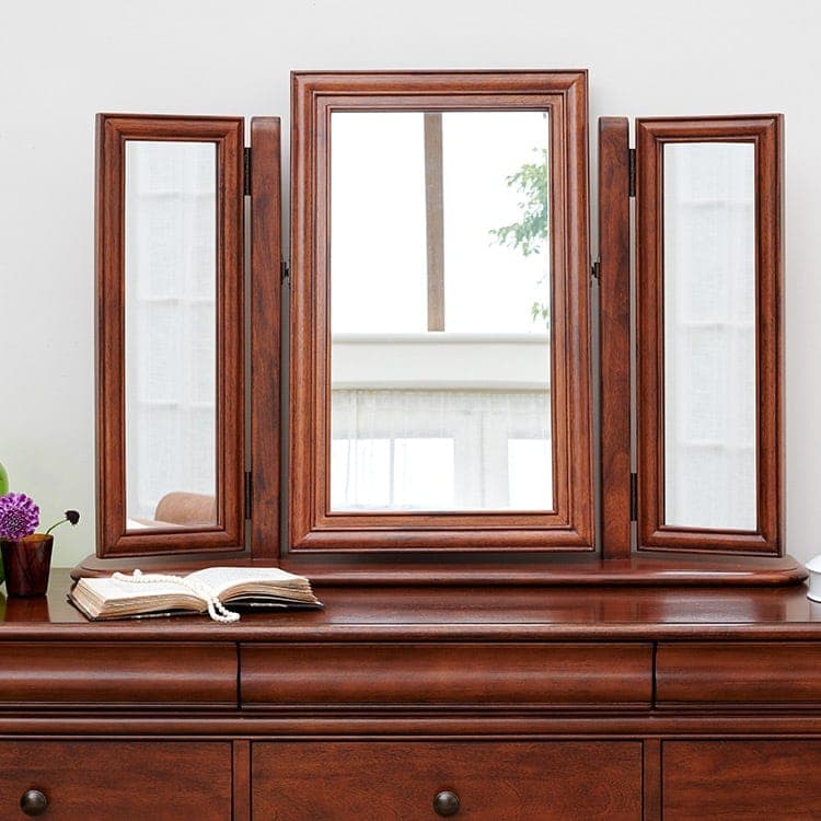 Antoinette dark mahogany gallery mirror resting above a chest of drawers